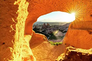 Cave Prints: Fairy chimneys through rock opening at sunset