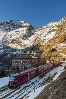 The famous Bernina Express red train at Alp Grum station, Graubunden, Switzerland