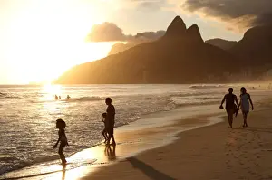 Dois Irmaos Prints: The famous Ipanema Beach in Rio de Janeiro with the Two Brothers Mountain in the background at sunset