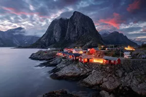 Images Dated 24th January 2023: The famous red cabins of Hamnoy catching the last light of the day on a explosive summer sunset