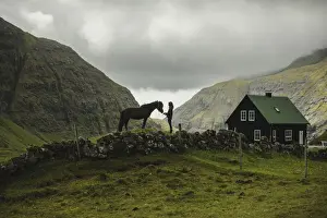 Saksun Prints: A Faroese girl with her horse in Saksun. Streymoy, Faroe Islands