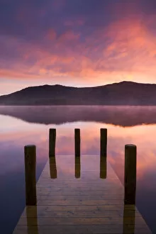 Jetty Gallery: Fiery sunrise over Derwent Water from Hawes End jetty, Lake District National Park