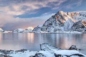 Fiord Hanningsvaer and peak Festvantind painted by the pink light at sunrise Fiord Hanningsvaer and peak Festvantind painted by the pink light at sunrise