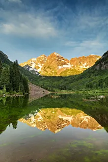 First Light on Maroon Bells Reflecting in Maroon Lake, near Aspen, Colorado, USA