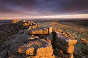Bleak Prints: The first rays of early morning sunlight bathe Higher Tor in a rich glow, Belstone Common