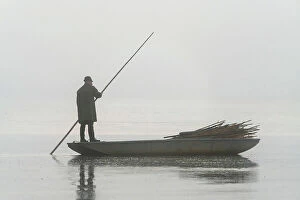 Basin Collection: Fisherman on boat preparing for fish harvest on foggy morning, Rozmberk Pond, UNESCO, Trebon