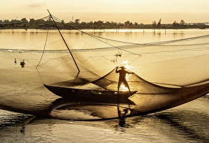 Hoi An Prints: Fisherman checking his net at sunrise