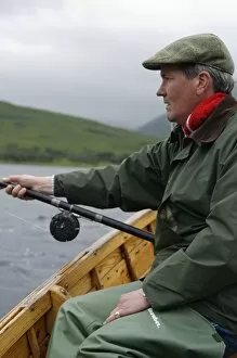 A fisherman dapping for salmon and sea trout on Loch Ba