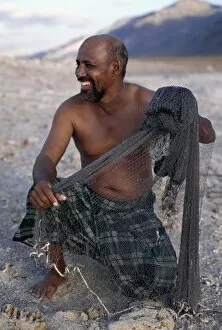 Socotra Island Collection: A fisherman near Di Hamri with his weighted throwing net