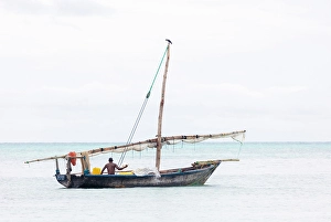 Zanzibar Prints: Fisherman on his traditional dhow, Nungwi, Zanzibar, Tanzania