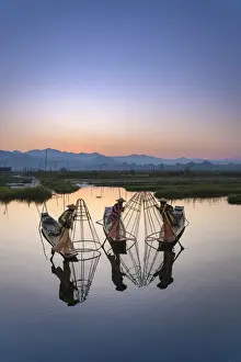 Non Urban Scene Prints: Three fishermen holding typical conical nets on their boats before sunrise
