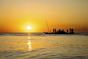Fishermen returning home on dhow at sunset, , Indian Ocean, Zanzibar, Tanzania
