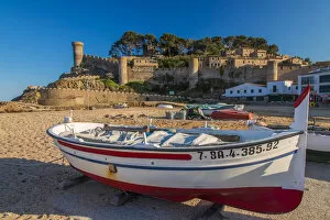 Sandy Collection: Fishing boat on the beach with medieval town walls in the background, Tossa del Mar
