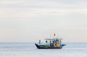 Hoi An Prints: Fishing boat heading to shore, Binh Minh fish market, near Hoi An, Vietnam