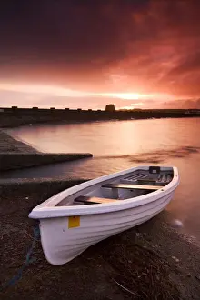 Powys Prints: Fishing boat tethered on the shores of the Usk Reservoir at sunrise