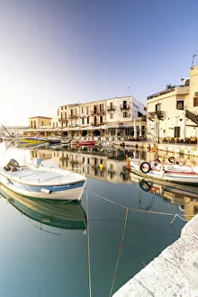Fishing boats moored in the old Venetian harbour at dawn, Rethymno, Crete island, Greece