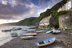 Fishing boats on the pebble beach in Clovelly harbour at dawn, Devon, England. Autumn