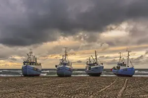Sustainable Prints: Fishing boats pulled ashore awaiting the storm in the small fishing village of