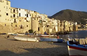 Cefalu Prints: Fishing boats pulled up on the beach outside the old town at sunset