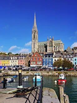 Fishing boats at the waterfront and St. Colman's Cathedral, Cobh, County Cork, Ireland