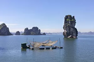Fishing nets on a raft in front of karst rocks, Halong Bay, Quang Ninh Province