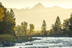 Peter Adams Gallery: Fly fisherwoman & fisherman casting & fishing on river, British Columbia, Canada