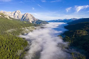 Above The Clouds Collection: Fog covering the green woods of Val Pusteria view from Passo di Monte Croce Comelico