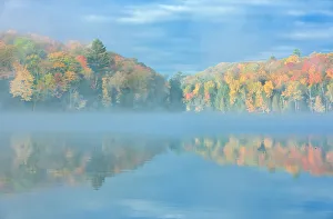 Fog on Horseshoe Lake in autumn with cottage, Near Parry Sound, Ontario, Canada