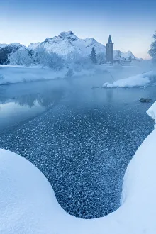Foggy sunrise in winter. Sils Maria, Sils im Engadin, Graubunden, Switzerland