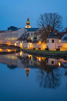 Footbridge over the Blind Shoulder of the Malse river named Muselak and tower of Dominican Monastery at twilight, Ceske Budejovice, South Bohemian Region, Czech Republic