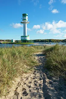 Footpath amidst grass against Friedrichsort lighthouse, Kiel, Schleswig-Holstein, Germany