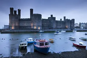 North Wales Prints: Foreboding evening skies above the immense Caernarfon Castle