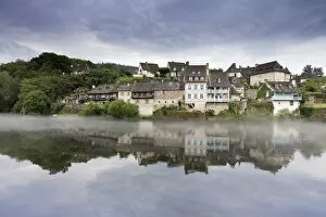 Images Dated 27th June 2017: France, Correze, Argentat, Old houses and a layer of mist are reflected in the Dordogne