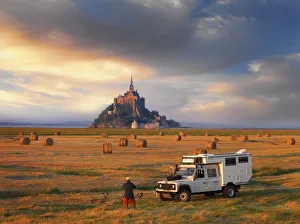 France, Normandy, Le Mont Saint Michel, Man and truck in hay field