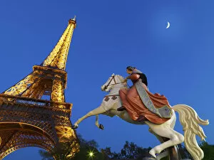 Images Dated 27th July 2011: France, Paris, Eiffel Tower illuminated at night, fairground horse in foreground
