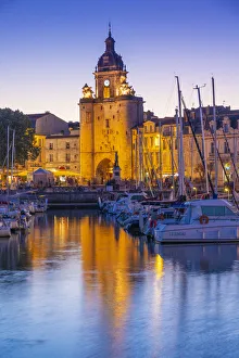France, Poitou Charentes, La Rochelle, Old Harbour, Porte de La Grosse Horloge at dusk