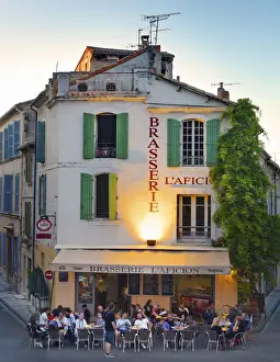Vertical Prints: France, Provence, Arles, People at brasserie infront of Amphitheatre at dusk