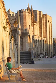 Vaucluse Gallery: France, Provence, Avignon, Palais de Papes, Woman reading book on bench MR