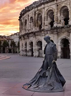 Images Dated 26th July 2012: France, Provence, Nimes, Roman ampitheatre, Toreador statue at sunset