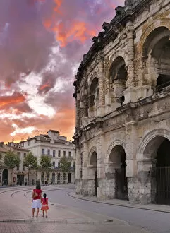 Images Dated 26th July 2012: France, Provence, Nimes, Roman ampitheatre, Woman and girl walking past arena MR