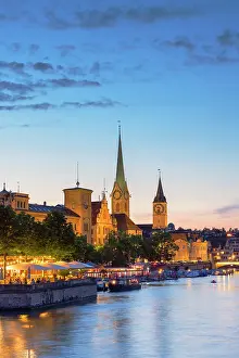 Beer Garden Prints: Fraumunster church, St Peter church and outdoor beer garden on Limmat River at dusk