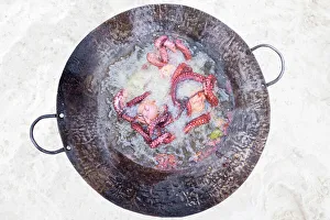 West Coast Prints: a freshly caught octopus is cooked on the beach, Zanzibar, Tanzania