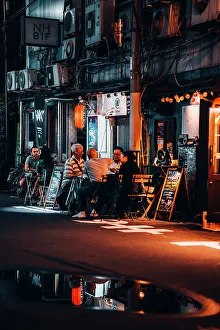 Kansai Prints: Friends chat and drink at a table in the streets of Osaka at night. Japan
