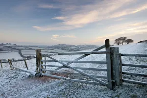 Frost covered wooden gate and field, Raddon Hills, Devon, England. Winter