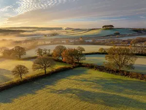 Frosty countryside with views to Cookworthy Knapp in the distance, Lifton, Devon, England. Autumn (November) 2023