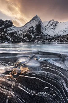 Frozen lake near Nusfjord at sunset, Lofoten islands, Norway