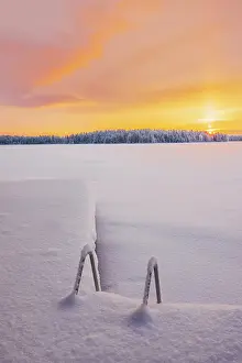 Finish Prints: A frozen lake at sunset in a remote area near Ruka in finnish Lapland in winter landscape