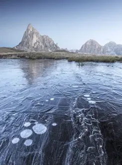 Ra Gusela Prints: A frozen puddle near the Giau Pass in the Dolomites provides a cool foreground during a freezing autumn morning