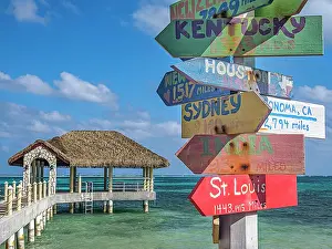 Signs Prints: Fun directional sign post along the Caribbean Sea on Grand Cayman