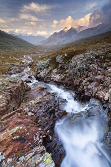 Gavia pass, Stelvio National park, Lombardy, Italy. Mountain river at sunset